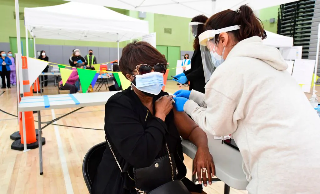 Carolyn Fowler of the Los Angeles Unified School District (LAUSD) receives her Covid-19 vaccination at a site opened by the LAUSD for its employees on February 17, 2021 in Los Angeles. (Frederic J. Brown/AFP via Getty Images)
