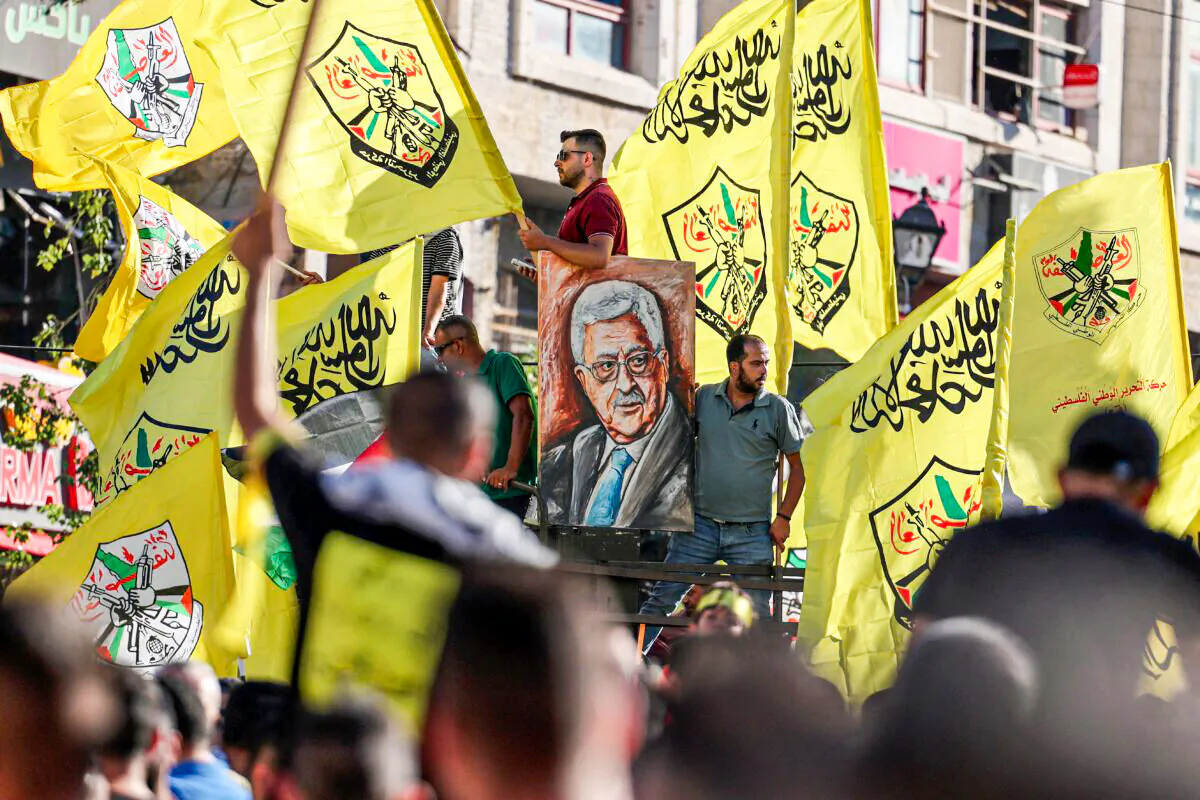 Palestinian supporters of Fatah rally in support of president Mahmoud Abbas in the occupied West Bank city of Ramallah, on July 10, 2021. (Abbas Momani/AFP via Getty Images)