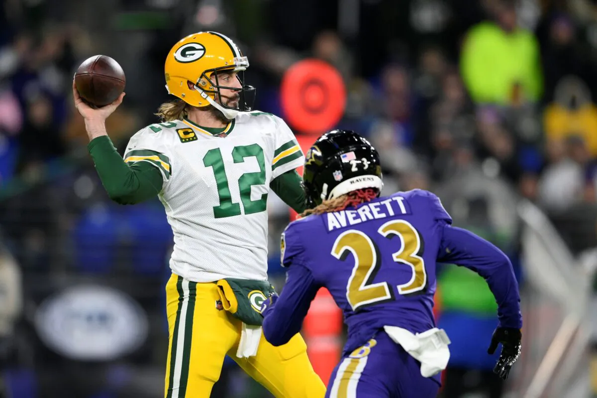 Green Bay Packers quarterback Aaron Rodgers (12) throws to a receiver as he is pressured by Baltimore Ravens cornerback Anthony Averett in the first half of an NFL football game in Baltimore, on Dec. 19, 2021. (Nick Wass /AP Photo)