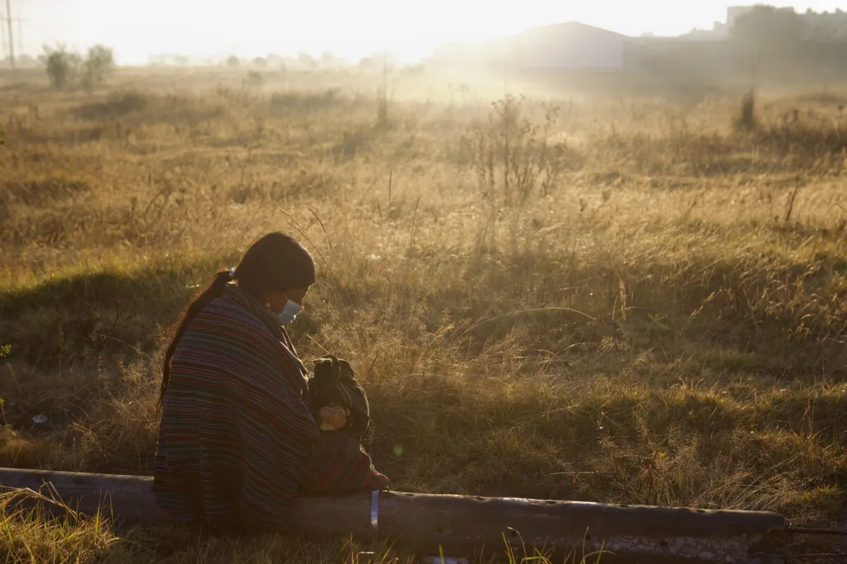A woman waits for the remains of relatives to take home from the morgue in Quetzaltenango, Guatemala, on Dec. 20, 2021. (Oliver De Ros/AP Photo)