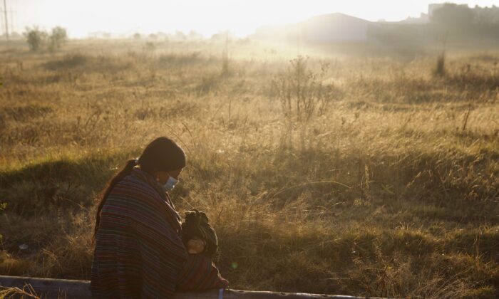 A woman waits for the remains of relatives to take home from the morgue in Quetzaltenango, Guatemala, on Dec. 20, 2021. (Oliver De Ros/AP Photo)