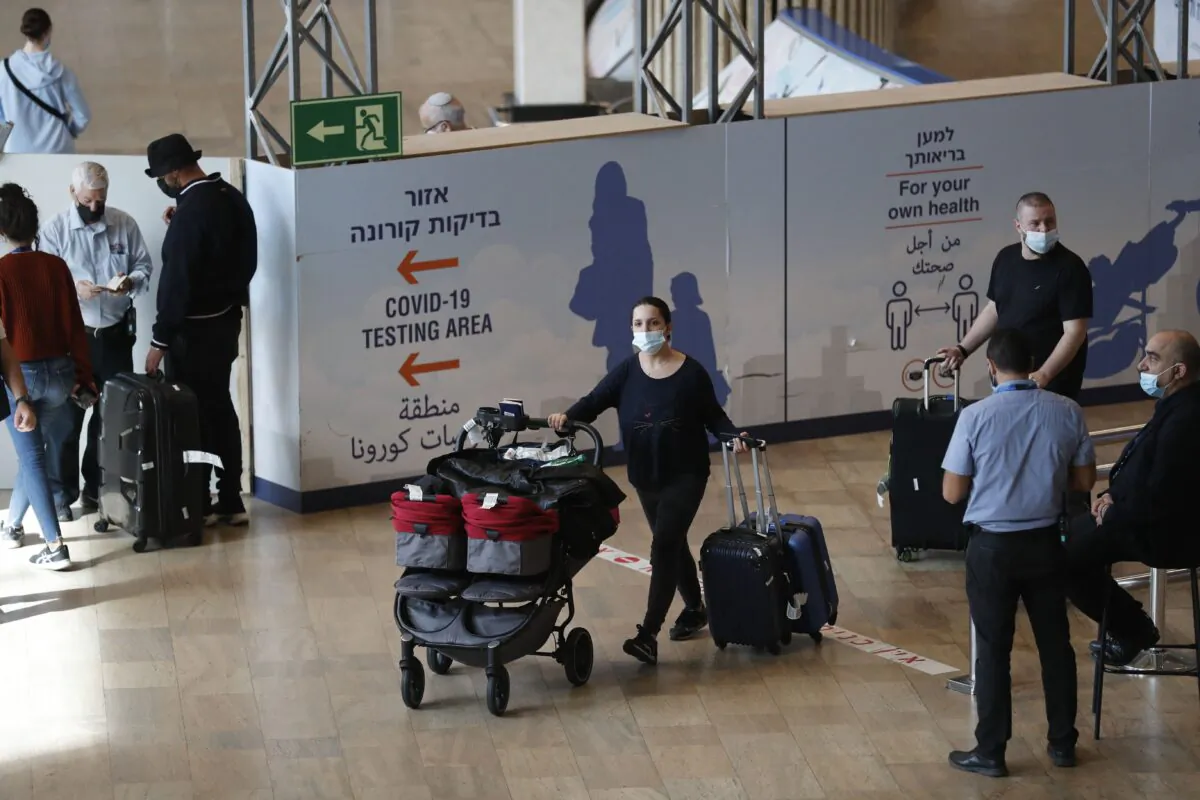 Passengers arrive to Israel's Ben Gurion Airport in Lod, east of Tel Aviv, on Nov. 28, 2021. (Ahmad Gharabli/AFP via Getty Images)