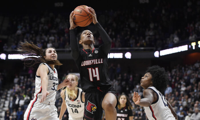 Louisville's Kianna Smith (14) goes up for a basket between Connecticut's Caroline Ducharme (33) and Christyn Williams (13), during an NCAA game in Uncasville, Conn., on Dec. 19, 2021. (Jessica Hill/AP Photo)