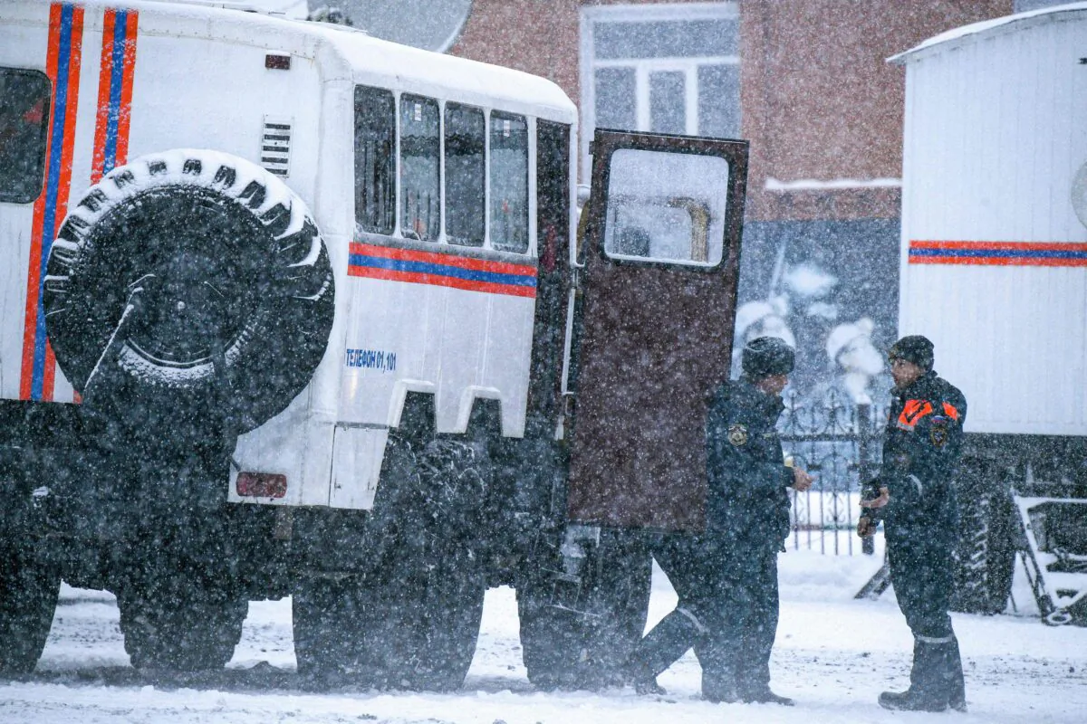 Rescuers in the Kemerovo region, Russia, on Nov. 25, 2021. (Alexander Patrin/AFP via Getty Images)