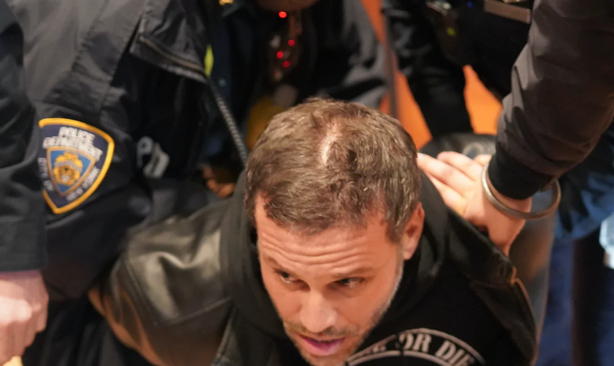Mitchell Bosch is arrested at a Panera in Brooklyn, New York, on Dec. 19, 2021. (Enrico Trigoso/The Epoch Times)