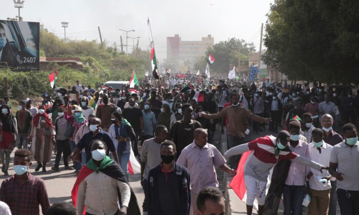 People take part in a protest against the October military takeover and a subsequent deal that reinstated Prime Minister Abdalla Hamdok but sidelined the movement in Khartoum, Sudan, on Dec. 19, 2021. (Marwan Ali/AP Photo)