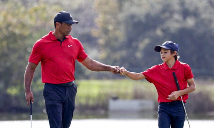 Tiger Woods and his son Charlie on the 12th hole during the second round of the PNC Championship golf tournament in Orlando, Fla., on Dec. 19, 2021. (Joe Skipper/Reuters)