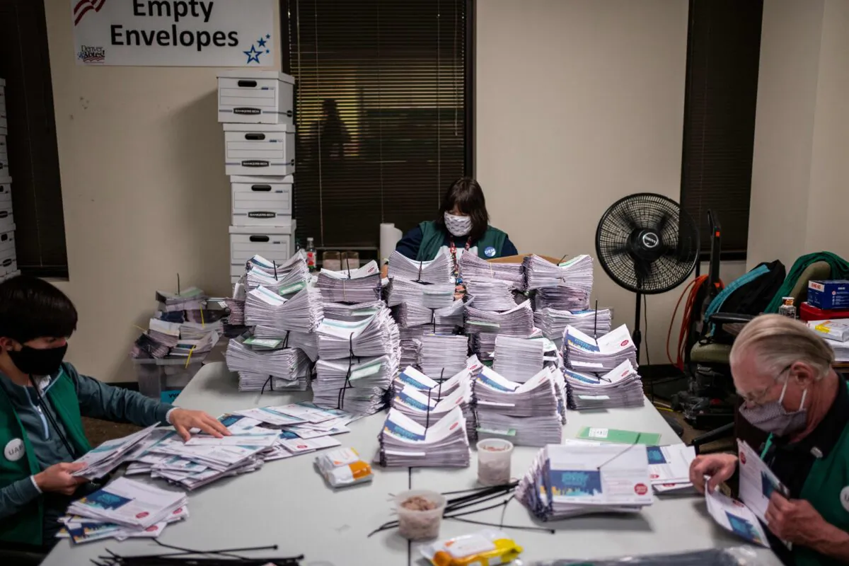 Election workers verify and count ballots at the Denver Elections Division building in Denver, Colo., on Nov. 3, 2020. (Chet Strange/AFP via Getty Images)