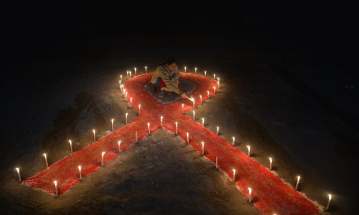 Candles form the shape of a ribbon as part of an awareness event on the occasion of World AIDS Day in Siliguri, India, on Dec. 1, 2018. (Diptendu Dutta/AFP via Getty Images)