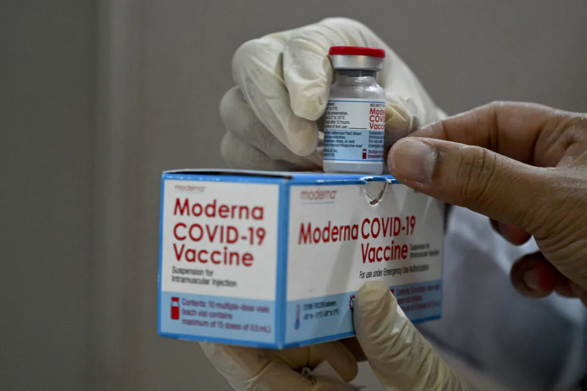 A health worker checks a box of the Moderna COVID-19 vaccine donated by the United States, during a booster vaccination drive at the Zainoel Abidin hospital in Banda Aceh, Indonesia, on Aug. 9, 2021. (Chaideer Mahyuddin/AFP via Getty Images)