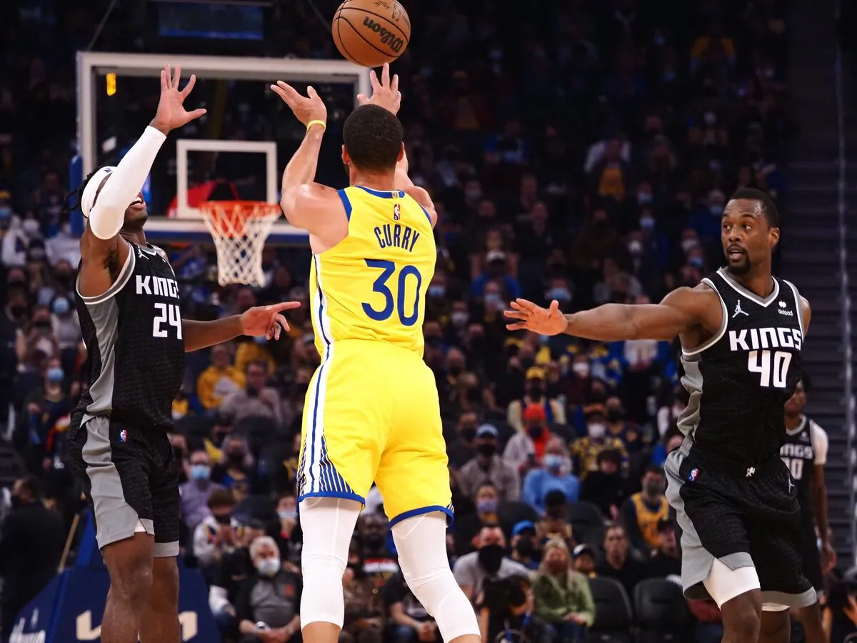 Sacramento Kings guard Buddy Hield (24) and forward Harrison Barnes (40) defend Golden State Warriors guard Stephen Curry (30) on a shot, during an NBA game at Chase Center, in San Francisco, Calif., on Dec. 20, 2021. (Kelley L Cox/USA TODAY Sports via Field Level Media)