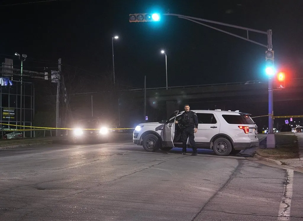 A Halifax Regional Police officer exits his vehicle at the scene of a fatal shooting in Dartmouth, N.S., Dec. 21, 2021. (The Canadian Press/Andrew Vaughan)