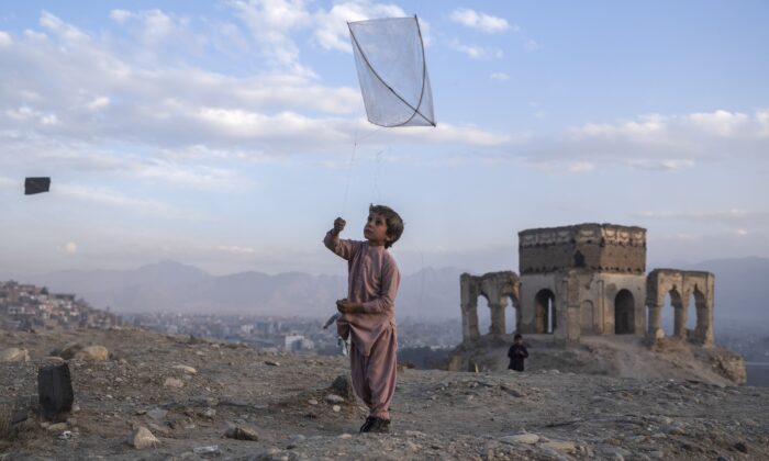 A boy flies a kite on Tape Nadir Khan hill in Kabul, Afghanistan, on Dec. 4 , 2021. (Petros Giannakouris/AP Photo)