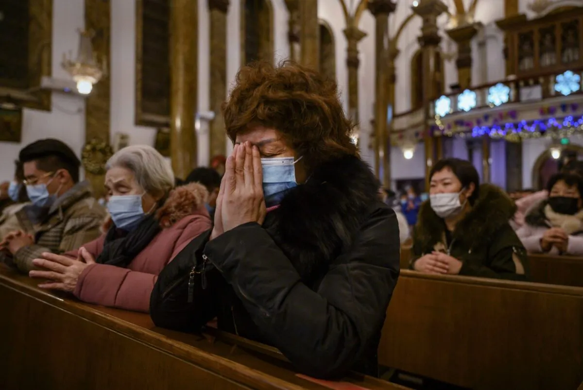 Chinese Christians pray during a Christmas Mass at a Catholic Church in Beijing, China, on Dec. 24, 2020.  (Kevin Frayer/Getty Images)