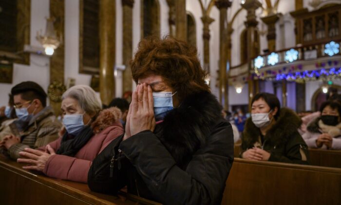 Chinese Christians pray during a Christmas Mass at a Catholic Church in Beijing, China, on Dec. 24, 2020.  (Kevin Frayer/Getty Images)