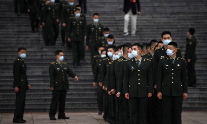 Military delegates stand in formation at the Great Hall of the People in Beijing on Oct. 9, 2021. (Noel Celis/AFP via Getty Images)