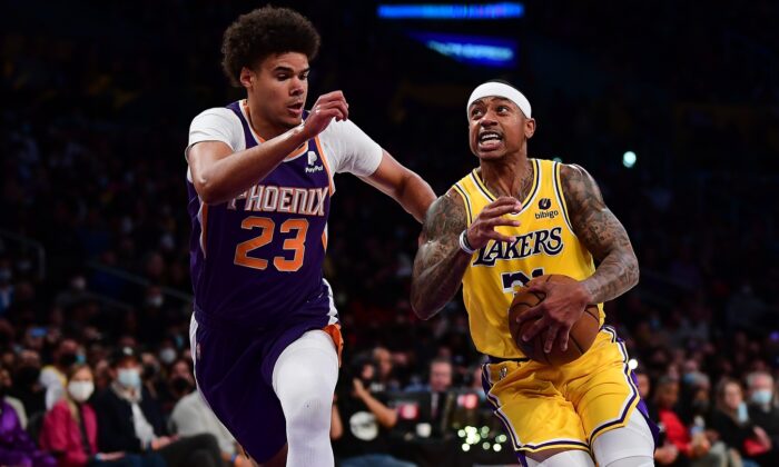 Los Angeles Lakers guard Isaiah Thomas (31) moves the ball against Phoenix Suns forward Cameron Johnson (23), during an NBA game at Staples Center, in Los Angeles on Dec. 21, 2021. (Gary A. Vasquez/USA TODAY Sports via Field Level Media)