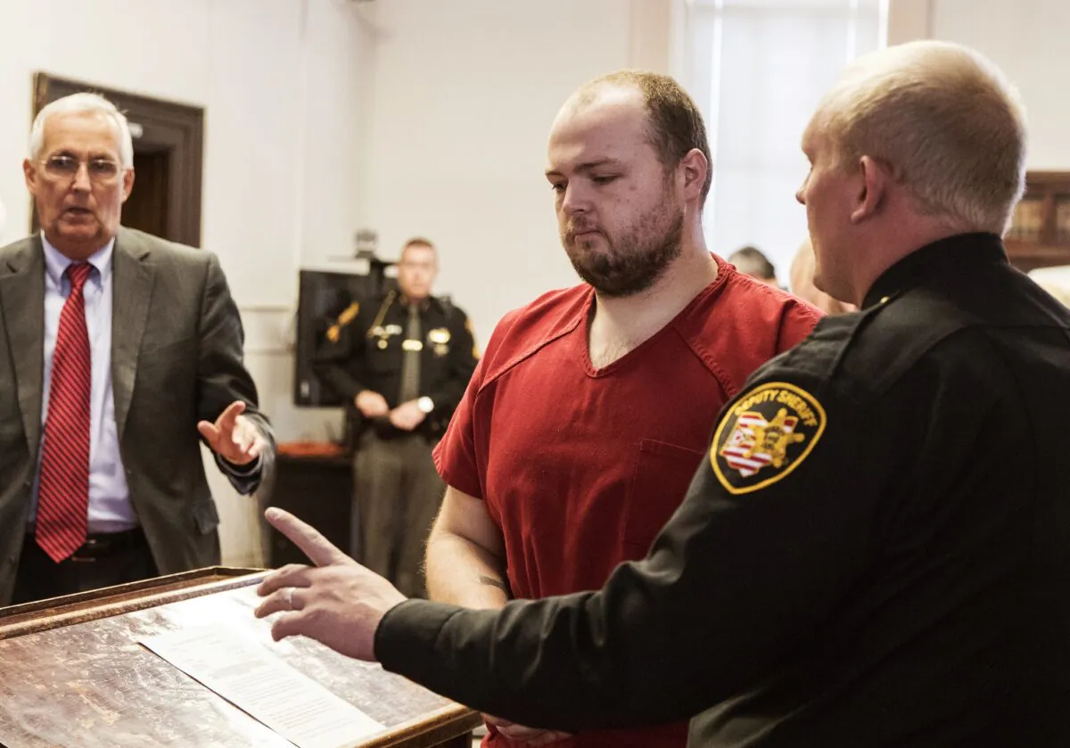 George Wagner IV, center, is escorted out of the courtroom after his arraignment at the Pike County Courthouse, in Waverly, Ohio, on Nov. 28, 2018. He will become the first Pike County Massacre suspect in the Pike County Massacre to face trial in August 2022. (Robert McGraw/The Chillicothe Gazette via AP)