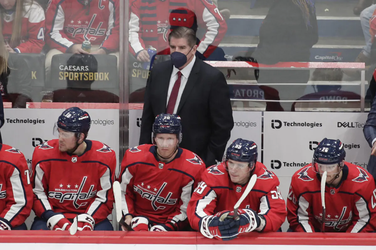 Washington Capitals head coach Peter Laviolette, center top, looks on during an NHL game against the Los Angeles Kings in Washington, on Dec. 19, 2021. (Luis M. Alvarez/AP Photo)