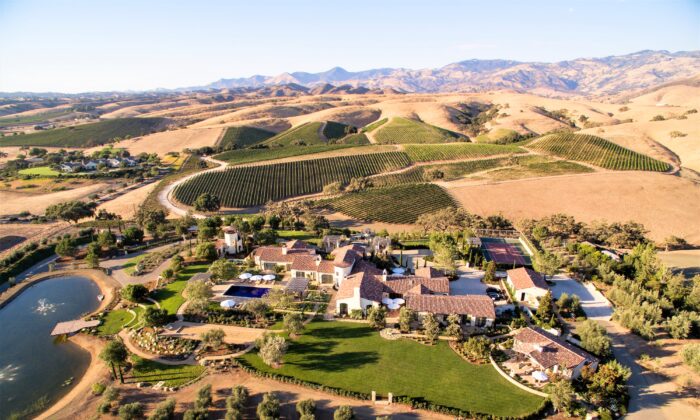 An aerial view of the estate shows the lush surroundings, horse farms, vineyards, and the San Rafael Mountains beyond. (Matthew Walla/Jade Mills)