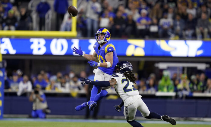Los Angeles Rams wide receiver Cooper Kupp, top, catches a pass over Seattle Seahawks cornerback Sidney Jones during the second half of an NFL football game in Inglewood, Calif., Dec. 21, 2021. (Ashley Landis/AP Photo)