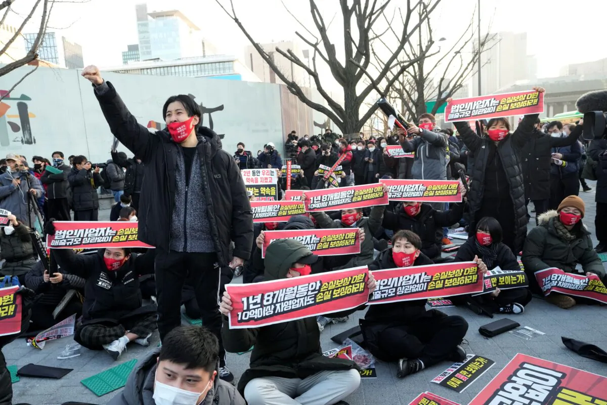 Small business owners stage a rally against the government's social distancing rules near the Government Complex in Seoul, South Korea, on Dec. 22, 2021. (Ahn Young-Joon/AP Photo)
