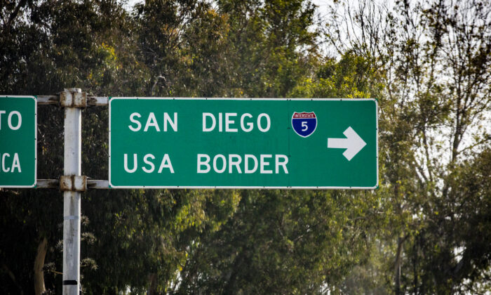 A roadsign in Tijuana, Mexico lpoints drivers to the USA/Mexico border city of San Diego, Calif., on Nov. 6, 2021. (John Fredricks/The Epoch Times)