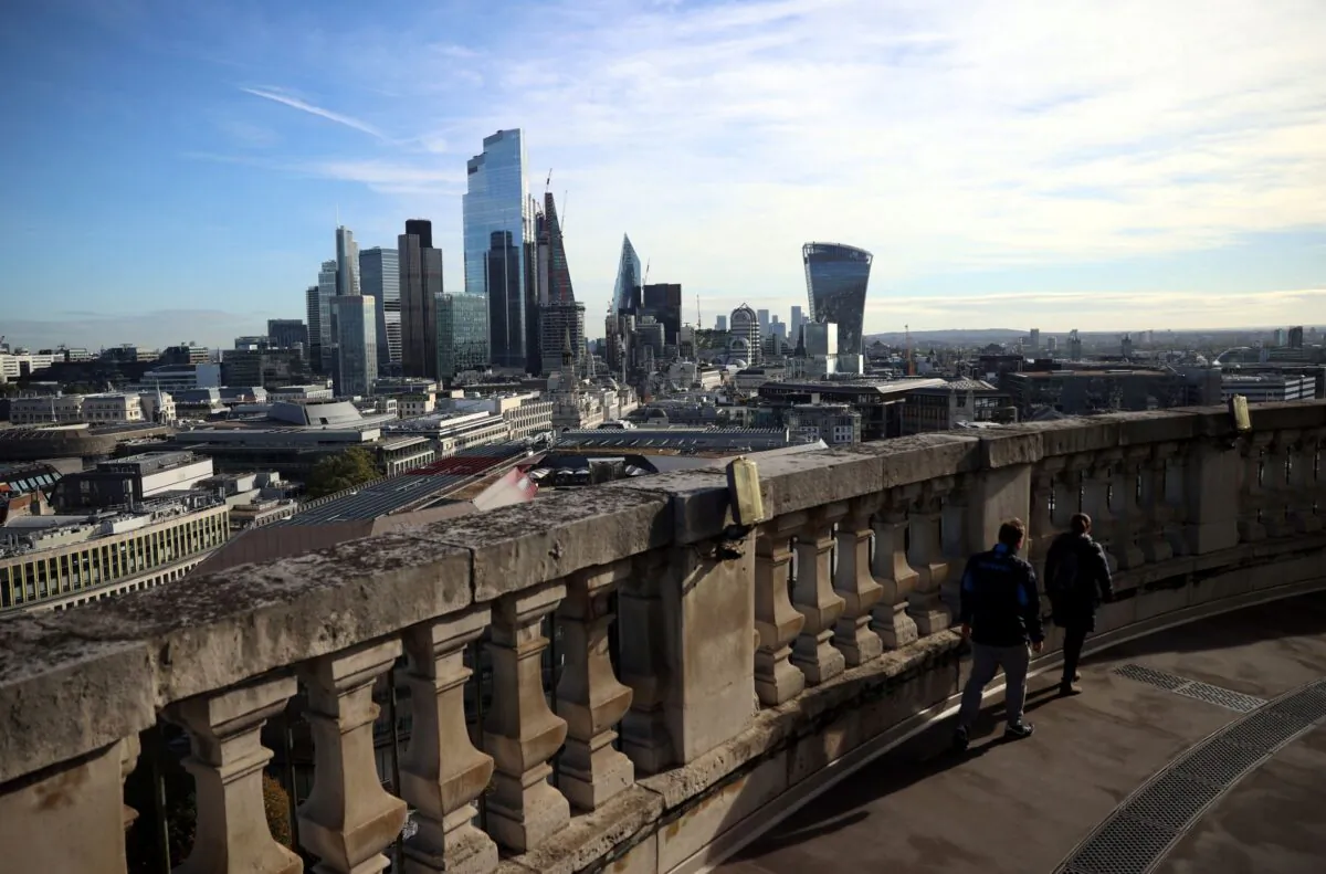 People look out to the City of London financial district from a viewing platform in London, Britain, on Oct. 22, 2021. (Hannah McKay/Reuters)