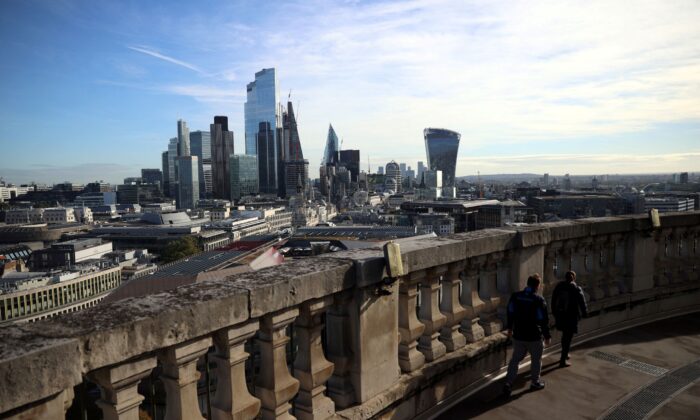 People look out to the City of London financial district from a viewing platform in London, Britain, on Oct. 22, 2021. (Hannah McKay/Reuters)
