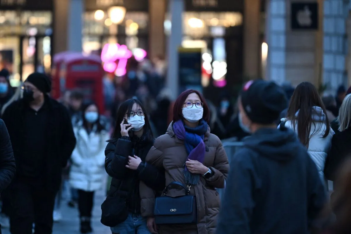 People walk in London on Dec. 21, 2021. (Justin Tallis/AFP via Getty Images)