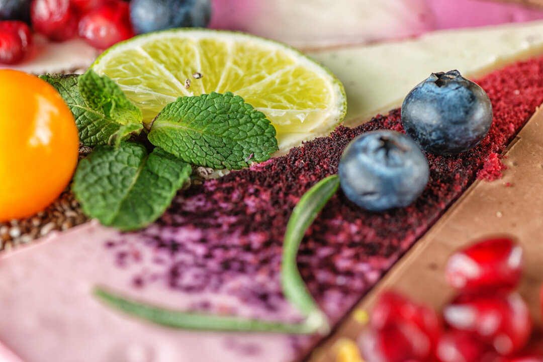 Garnish the pie with cranberries, pomegranate seeds and flowers.  By Martin Gaal/Shutterstock