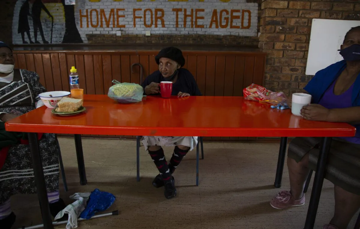 People eat at the Soweto Home For The Aged in Johannesburg, South Africa on Dec. 14, 2021. (Denis Farrell/AP Photo)