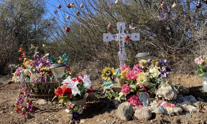 An elaborate display featuring a cross and bouquets of flowers was set up on US Route 17 heading southbound. The name of the crash victim is covered on on Dec. 13, 2021. (Allan Stein/The Epoch Times)