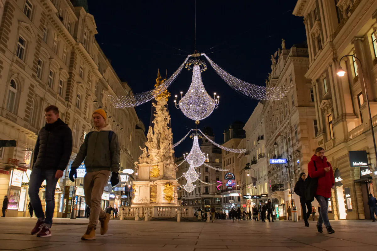 People walk past closed shops at 'Am Graben' shopping street in Vienna, Austria, during a nationwide lockdown on Nov. 24, 2021. (Thomas Kronsteiner/Getty Images)