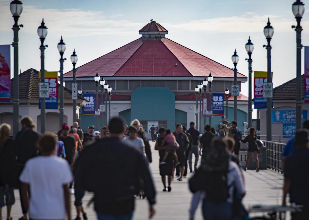 People walk past the former Ruby's Diner site, which stopped operation in February 2021, at the end of the Huntington Beach Pier in Huntington Beach, Calif., on Sept. 22, 2021. (John Fredricks/The Epoch Times)