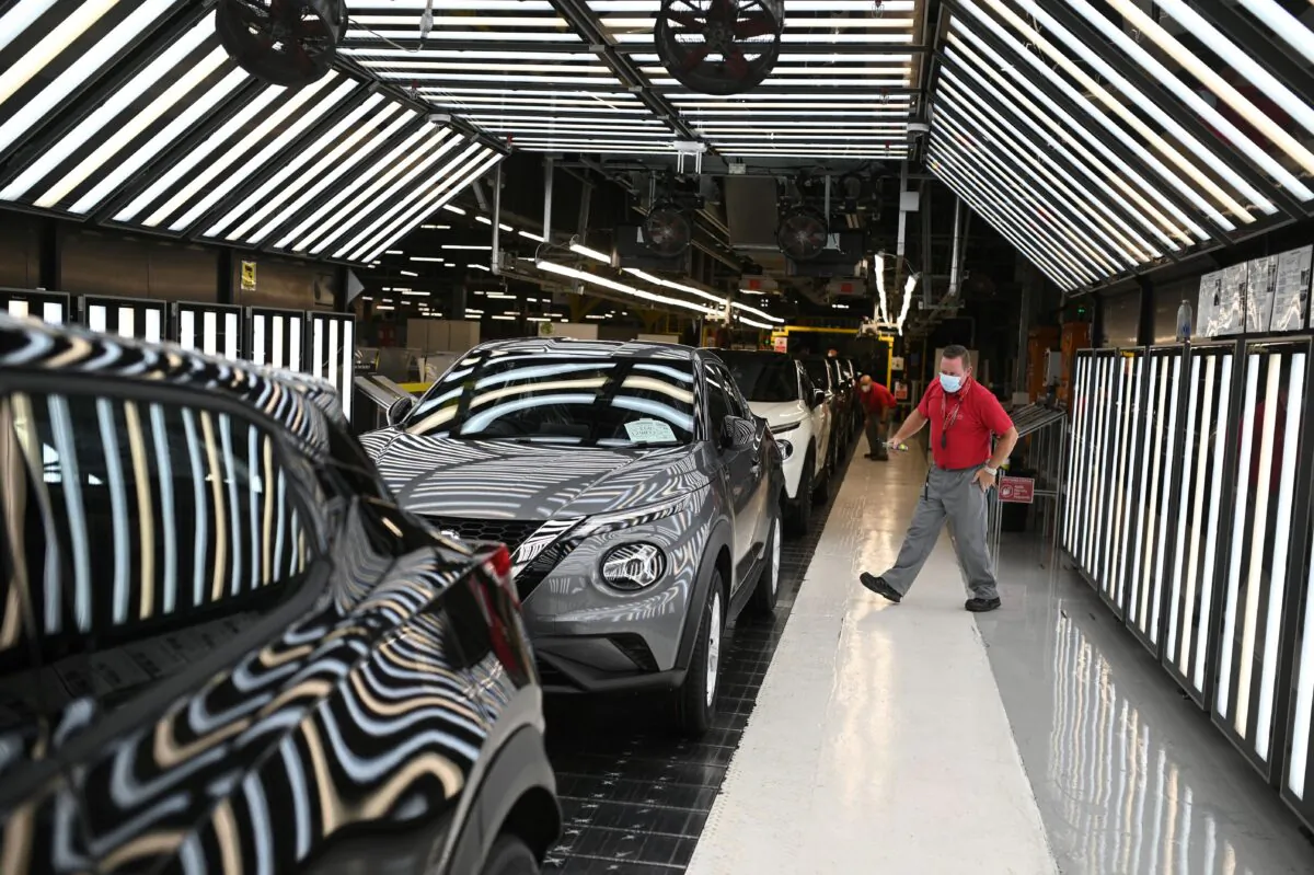 Nissan employees make final checks to cars on the production line at Nissan's plant in Sunderland, north east England on July 1, 2021. (Oli Scarff/AFP via Getty Images)