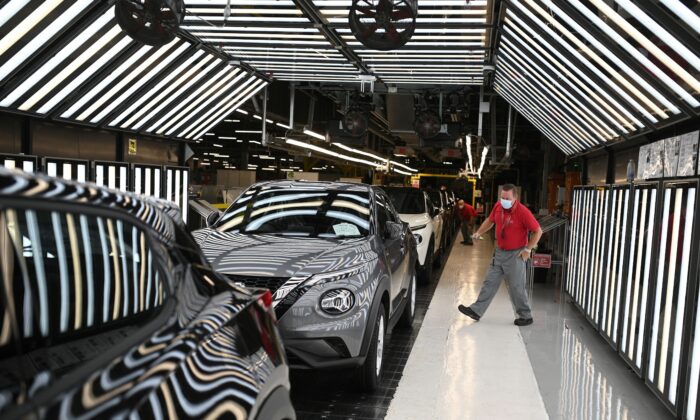 Nissan employees make final checks to cars on the production line at Nissan's plant in Sunderland, north east England on July 1, 2021.  (Oli Scarff/AFP via Getty Images)