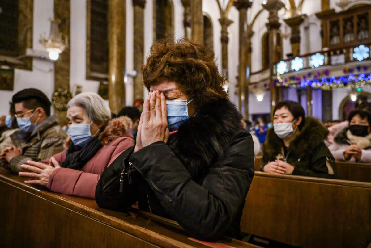 Chinese Christians pray during a Christmas Mass at a Catholic Church on Dec. 24, 2020 in Beijing, China.  (Kevin Frayer/Getty Images)