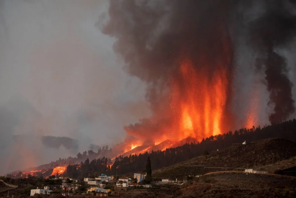 Mount Cumbre Vieja erupts in El Paso, spewing out columns of smoke, ash, and lava as seen from Los Llanos de Aridane on the Canary island of La Palma in Spain, on Sept 19, 2021.  (Desiree Martin/AFP via Getty Images)