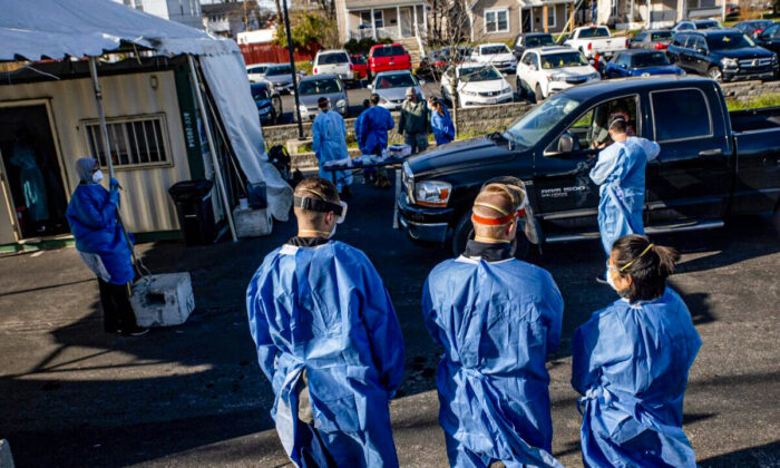 Healthcare workers administer free COVID-19 tests to people in their cars in the parking lot of the Columbus West Family Health and Wellness Center, in Columbus, Ohio, on Nov. 19, 2020. (Stephen Zenner/AFP via Getty Images)