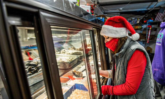 An employee fills a container with minced clam meat at a store in Revere, Mass., on Dec. 23, 2020. (Joseph Prezioso/AFP via Getty Images)