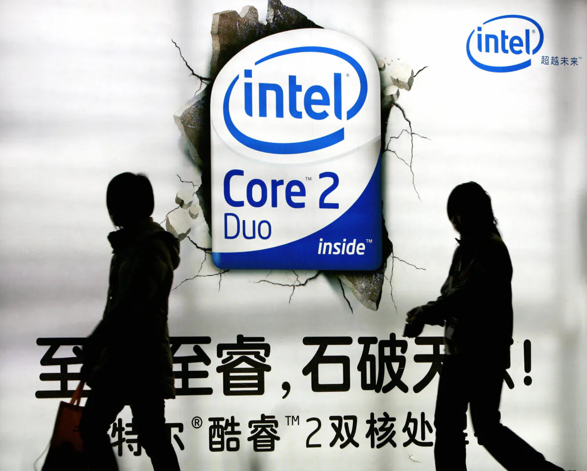 Chinese shoppers walk past an advertising billboard of the U.S. chip giant Intel on display at a shopping mall in Beijing, China, on March 26, 2007. (Teh Eng Koon/AFP via Getty Images)