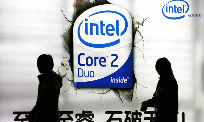 Chinese shoppers walk past an advertising billboard of the U.S. chip giant Intel on display at a shopping mall in Beijing, China, on March 26, 2007. (Teh Eng Koon/AFP via Getty Images)