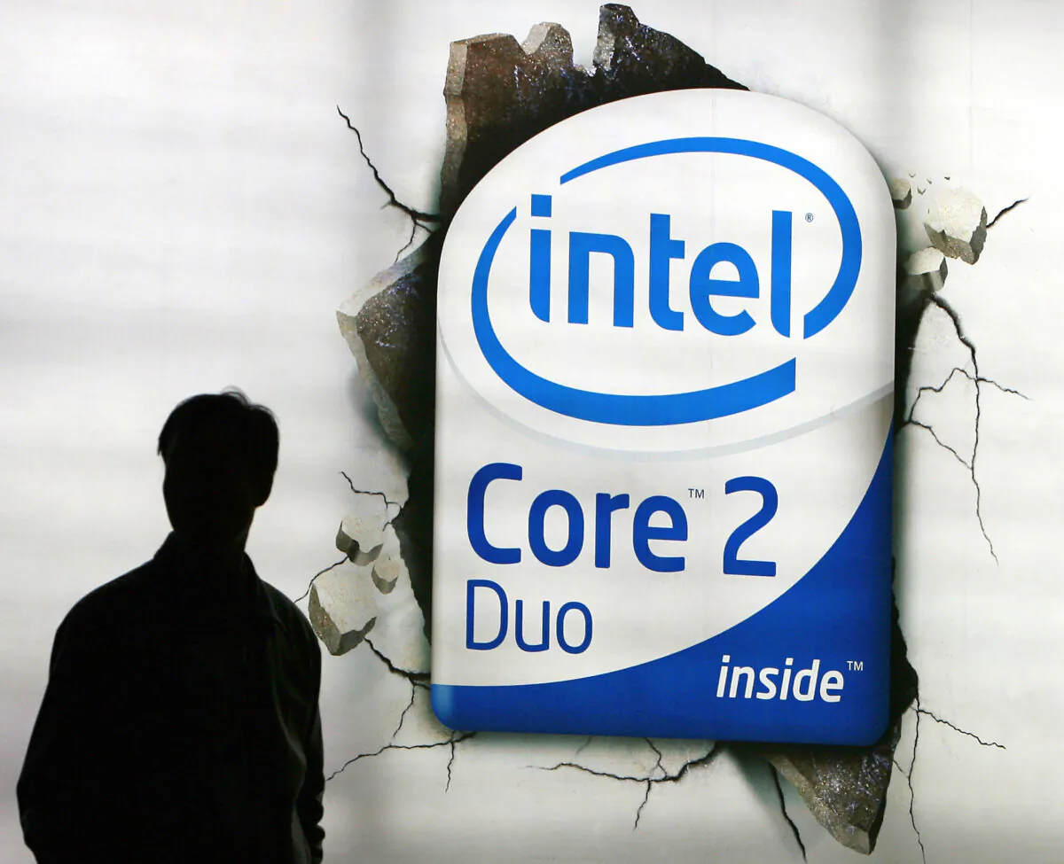 A Chinese shopper walks past an advertising billboard of the U.S. chip giant Intel on display at a shopping mall in Beijing on March 26, 2007. (Teh Eng Koon/AFP via Getty Images)