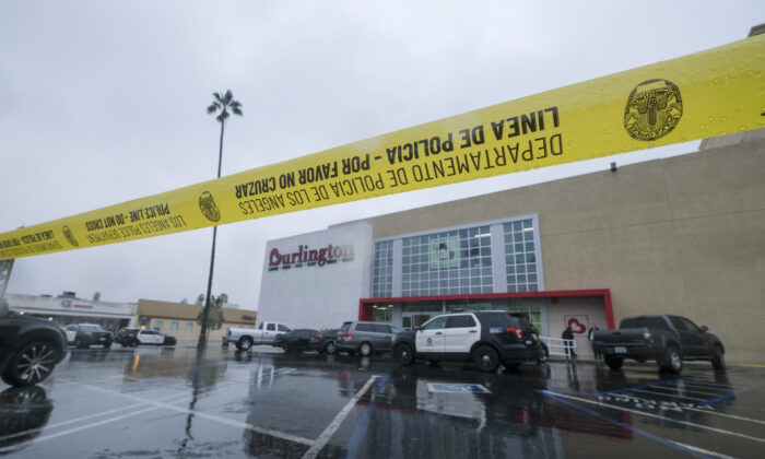 Police tape at the scene where two people were struck by gunfire in a shooting at the Burlington Coat Factory store in North Hollywood, Calif., on Dec. 23, 2021. (Ringo H.W. Chiu/AP Photo)