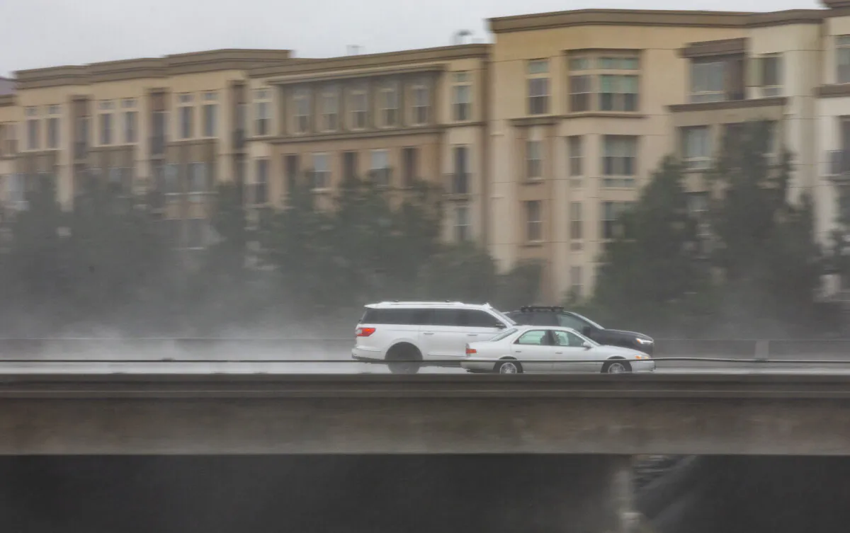 Cars driving during a rainstorm on the the 405 Freeway in Irvine, Calif., on Dec. 12, 2021. (John Fredricks/The Epoch Times)