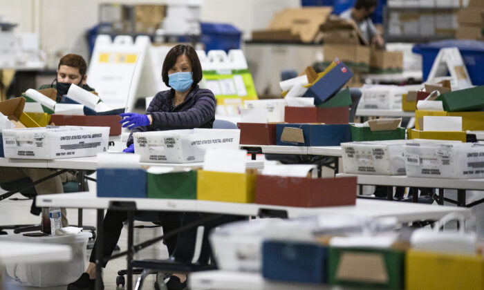 Los Angeles Registrars Office personnel process mail in voting ballots in Pomona, Calif., on Aug. 31, 2021. (John Fredricks/The Epoch Times)