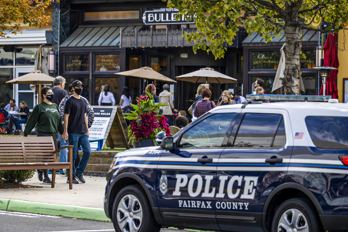 A police car is parked outside as people visit Mosaic Shopping Center Mall Fairfax, Vir., on October 30, 2021 in . (Tasos Katopodis/Getty Images)