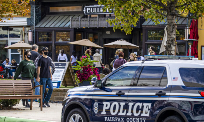A police car is parked outside as people visit  Mosaic Shopping Center Mall Fairfax, Vir., on October 30, 2021 in .  (Tasos Katopodis/Getty Images)