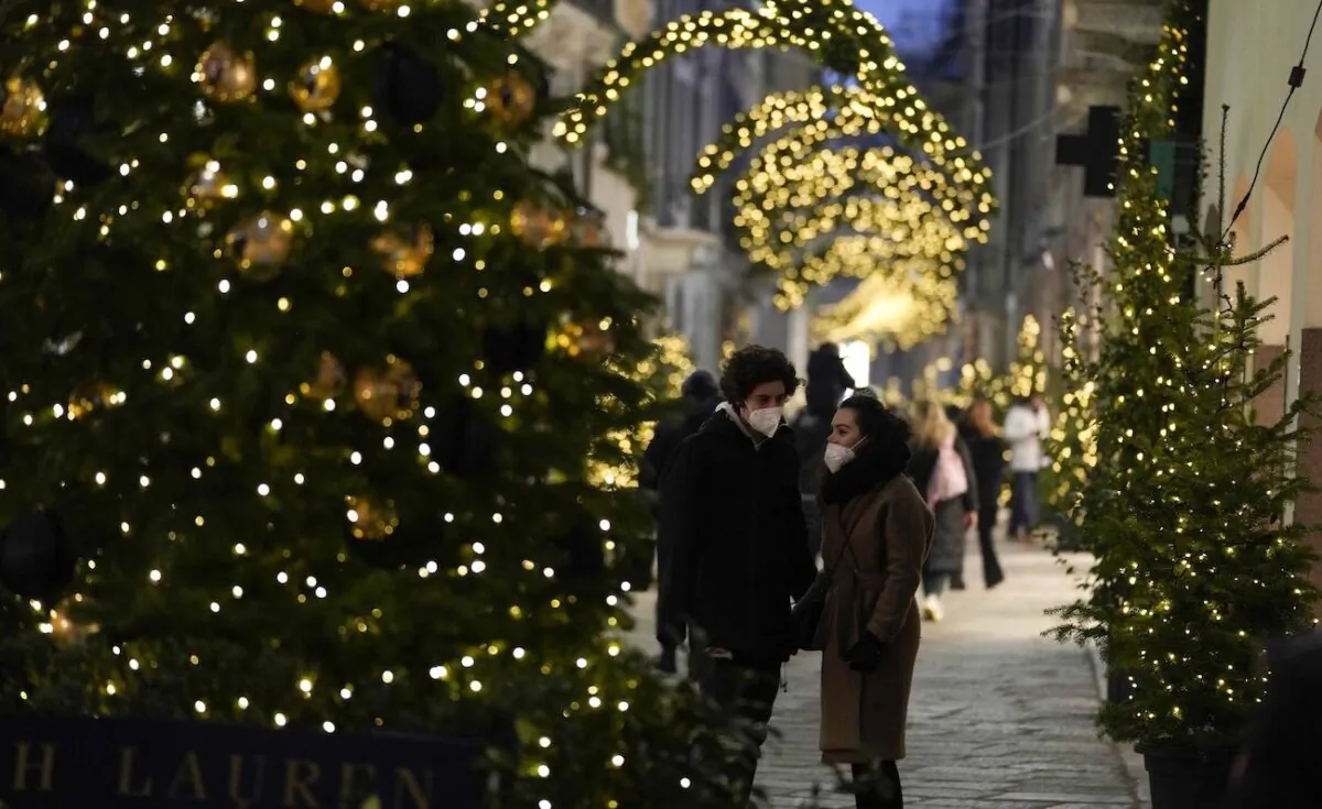 Pedestrians stroll along Via Montenapoleone fashion district in Milan, Italy, on Dec. 23, 2021. (Luca Bruno/AP Photo)